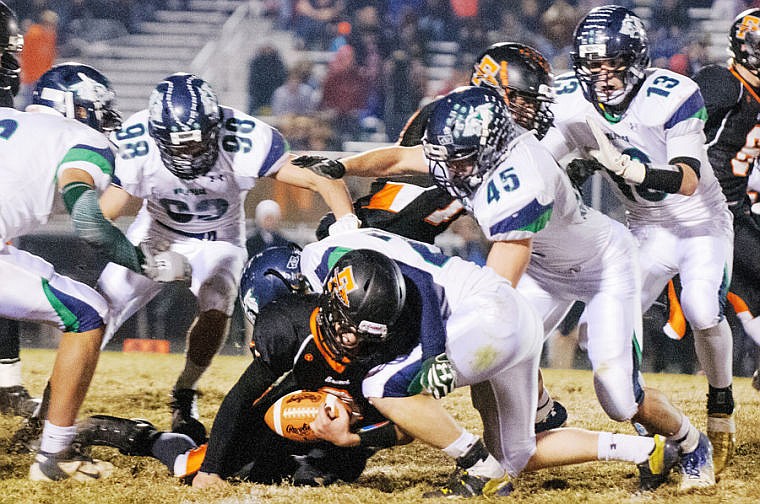 &lt;p&gt;Glacier&#146;s Orie Mann takes down Flathead quarterback Easton Johnson Friday night during the&#160; crosstown football game at Legends Stadium. Johnson led the Braves in passing, rushing and receiving yards against the Wolfpack. Glacier moves on to the Class AA playoffs as the No. 2 seed and will play No. 7 Butte next week.&lt;/p&gt;