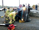Firefighters free woman trapped under SUV