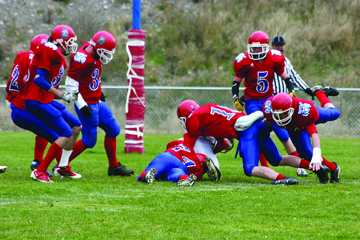 The Bobcats stop a Trojan just before the end zone on Saturday.