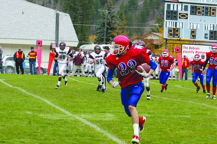 RJ Frederick carries the ball down the field in a game against Troy on Saturday. After winning the district Title, Superior beat the Trojans in the first playoff game.