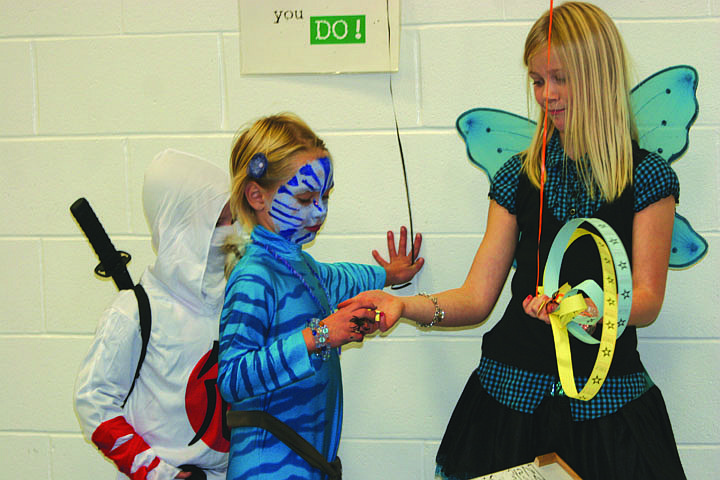 Kirsten Hill hands tickets to Kylie Plakke as Carter McLees waits his turn to play Plinko.