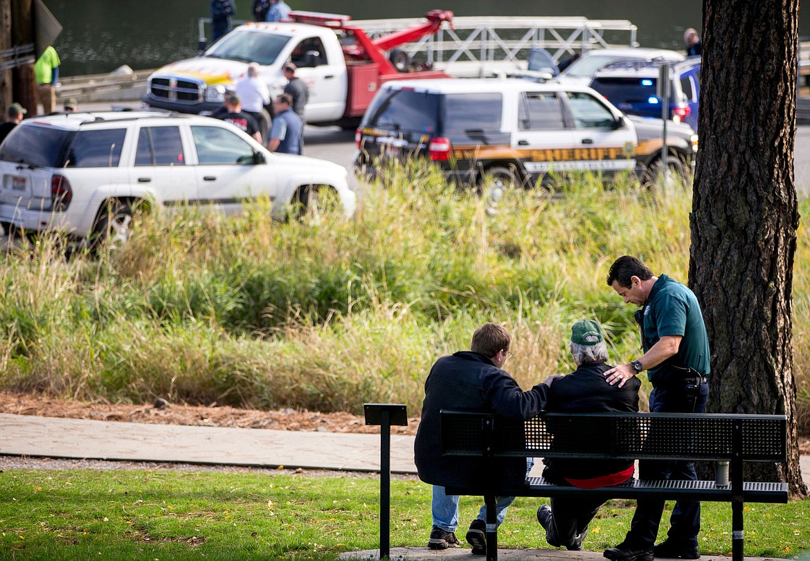 &lt;p&gt;Two law enforcement members counsel the man who discovered a fully submerged sedan at the Fernan Lake boat launch Thursday morning. The Kootenai County Sheriff's Office has confirmed two children and an adult female died on-scene.&lt;/p&gt;