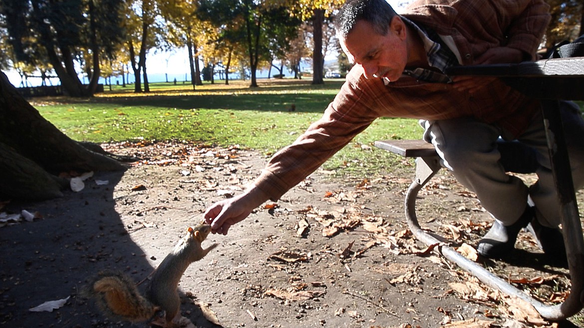 &lt;p&gt;Paul Parla hands a squirrel an acorn on Thursday at City Park in Coeur d'Alene. Parla visits with and feeds the squirrels every day.&lt;/p&gt;