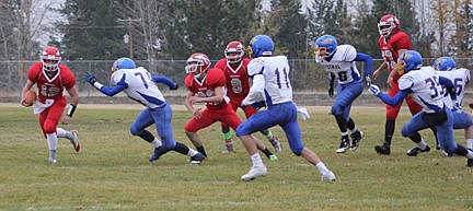 &lt;p&gt;Arlee quarterback Riley Rogers runs around the Central defense.&lt;/p&gt;