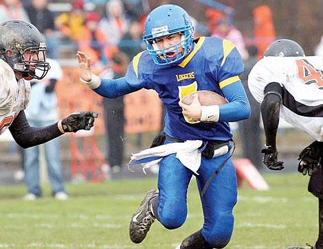 Libby sophomore quarterback Joel Fuller heads upfield on a keeper during first-half action Saturday in Libby&#146;s Class A football quarterfinal win over Hardin. Fuller was 14-for-20 for 271 yards and two touchdowns. The Loggers won, 33-13. Photo courtesy Paul Sievers/The Western News