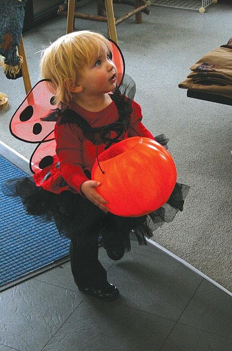 Jamie Doran/Valley Press Madalynn Blood, 16 months, looks up for candy Friday in Plains.