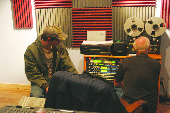 Roman Zylawy talks with Chuck Seward about their CD as Seward adjusts some items.