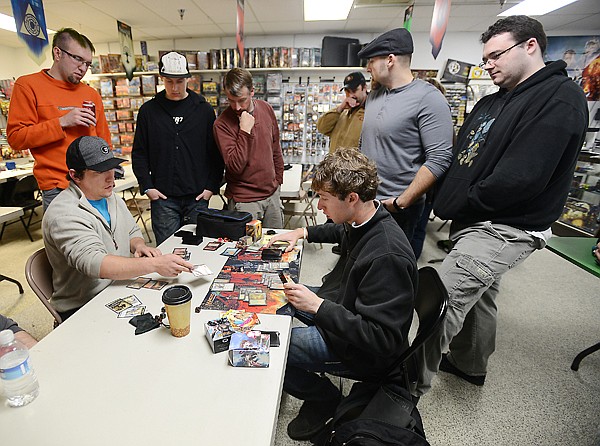 &lt;p&gt;Participants in the Magic Tournament gather around Chase Kolodejchuk of Columbia Falls, left, and Kevin Wallner of Kalispell as they play out the last game in round one on Oct. 27, at Heroic Realms in Evergreen. Magic was introduced in 1993. It is the longest running collectable card game.&lt;/p&gt;