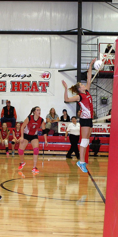 <p>Nicole Zavoianu blocks the ball during the game against Superior while her teammate Katie Chandler watches.</p>