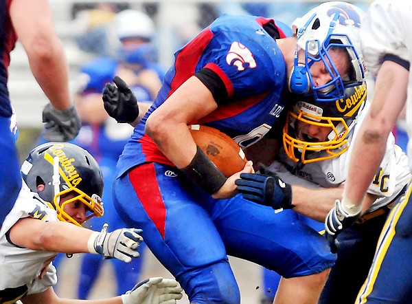 Columbia Falls' Austin Barth is halted by the Custer County defense in the fourth quarter during Saturday afternoon's Class A playoff game in Columbia Falls. The WIldcats were held scoreless in the second half.