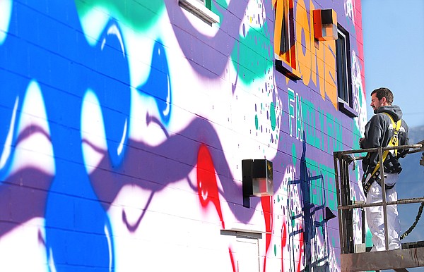 Brad Briney of Amazing Painting Inc. works on the detailing of a mural he made for the Zone Family Fun Center on Highway 2 north of Kalispell on Thursday afternoon. The Zone plans to open sometime in December.