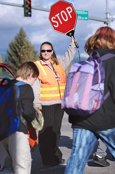 Chrystal Shue of Evergreen holds traffic as students from Evergreen  Junior High School cross Highway 2 on Tuesday afternoon.