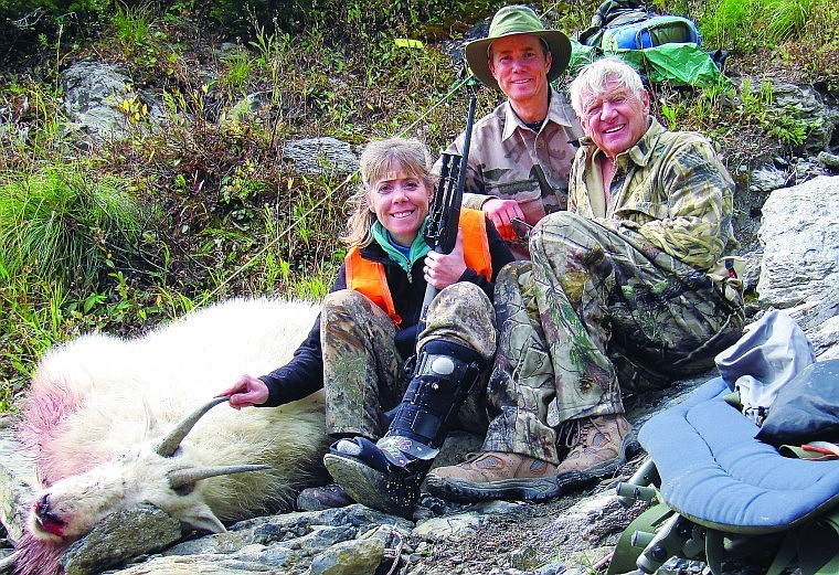 Whitefish resident Nanci Nicholson, her husband Rob, and her father, Martin Hale, rest with a billy goat she shot on a mountain high up in the Great Bear Wilderness. It was an extraordinarily difficult hunt because Nicholson recently had foot surgery and was hiking in an orthopedic boot.