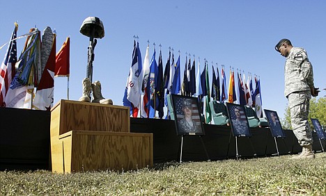 &lt;p&gt;A soldier views a Soldier's memorial and victim's photos during a Remembrance Ceremony commemorating the one-year anniversary of the worst mass shooting on a U.S. military base, where 13 people were killed and dozens wounded, Friday in Fort Hood.&lt;/p&gt;