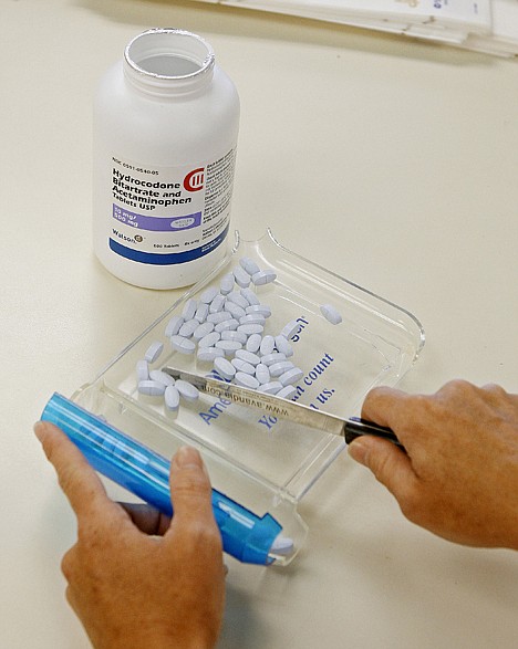 &lt;p&gt;A pharmacy technician counts hydrocodone tablets.&lt;/p&gt;