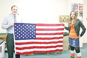 &lt;p&gt;Troy High School Principal Jacob Francom and Troy senior Michaela Curry hold one of the two flags.&lt;/p&gt;