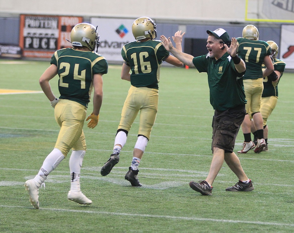 &lt;p&gt;JASON ELLIOTT/Press&lt;/p&gt;&lt;p&gt;St. Maries assistant coach Greg Rouse congratulates Kaden Hammond (16) and Dylan Edwards (24) after a defensive stop in the fourth quarter of Saturday's state 2A football quarterfinal game at the Kibbie Dome in Moscow. St. Maries beat North Fremont 33-14 to advance to the 2A semifinals next weekend.&lt;/p&gt;