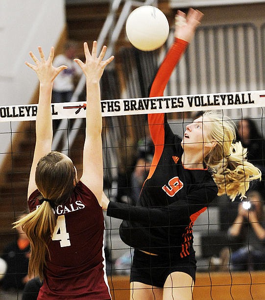 <p>Flathead's Tiana Johnson smashes the ball over a Helena defender during the Bravettes' five-set win. (Aaric Bryan/Daily Inter Lake)</p>