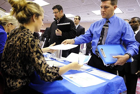 &lt;p&gt;Clarence Turner of Little Canada, Minn., hands in his resume at the Minneapolis Career Fair held in Bloomington, Minn., on Thursday.&lt;/p&gt;