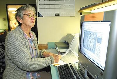 Eleanor Benz of Kalispell researches her husband's ancestry Wednesday afternoon at the Church of Jesus Christ of Latter-day Saints in Kalispell. The church has internet access for patrons and members alike to do online research on sites such as familysearch.or and programs such as Heritage Quest.