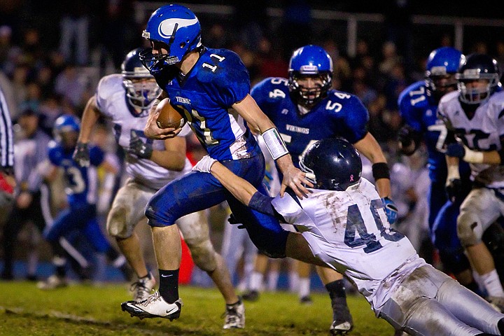 &lt;p&gt;Coeur d'Alene High quarterback Chad Chalich makes a break up the middle of the field as Beau Martz from Lake City High attempts to drag him down from behind during the second half of the Vikings 45-13 win Friday over the Timberwolves.&lt;/p&gt;