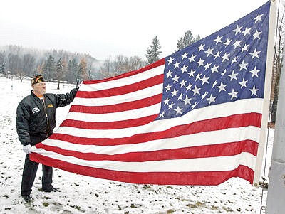 &lt;p&gt;VFW Post 1548 member Lorenzo Lamantia readies Old Glory during the Venterans Day ceremony at Libby Cemetery Monday morning.&lt;/p&gt;