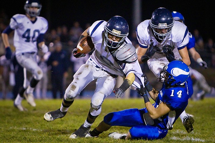 &lt;p&gt;Lake City High's Colton Carlson is dragged down by his jersey by Carlos Martinez from Coeur d'Alene High during the first half. Dylan Eastin from Lake City, right, comes in to break up the tackle.&lt;/p&gt;