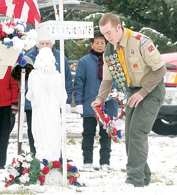 &lt;p&gt;Patrick Faulkner of Boy Scout Troop 1971, places a wreath as Stella Sharp, left, and Maria Wegner look on.&lt;/p&gt;