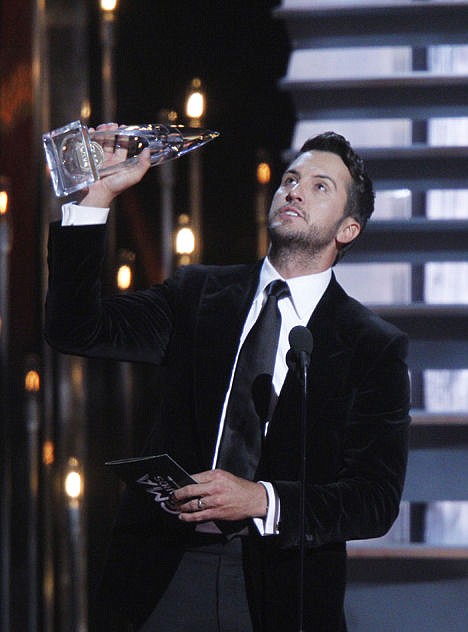 <p>Luke Bryan accepts the award for entertainer of the year onstage at the 48th annual CMA Awards.</p>