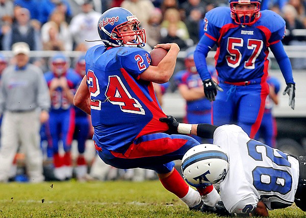 Bigfork's Travis Knoll (24) gets his jersey stretched out by Townsend's Boone Helm (82) as he attempts to gain more yardage on the play during Saturday's Class B Playoff game in Bigfork. Knoll ran for a total of 275 yards  on the game, including a 75 yard touchdown run that gave the Vikings their first score of the game.