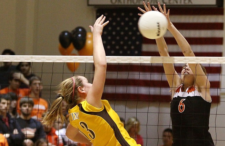 Flathead's Kwyn Johnson stretches to block Helena Capital's Sammi Bignell's spike during Thursday evening's Western AA play-in match.