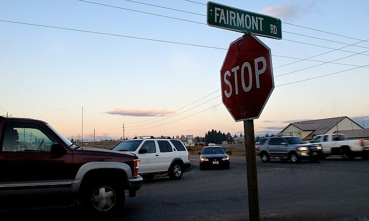 Traffic moves on Montana 35 Tuesday morning as a driver waits to turn onto the highway. A temporary traffic light at the intersection was removed following a study by the Montana Department of Transportation that suggested the light was no longer needed due to the opening of a new bridge over the Flathead River.