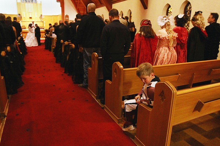 Jake Rendina plays with a laser pointer at the start of George and Nichole Heyer&#146;s wedding ceremony at Christ Church Episcopal in Kalispell on Halloween night.