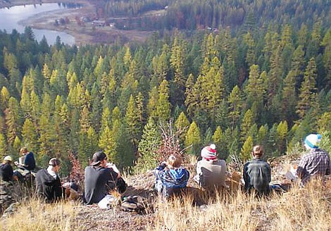 Students from Whitefish Independent High School take a lunch break at a spot overlooking Skyles Lake after working all morning on the Trail Runs Through It project north of Whitefish. The project was an opportunity for students at the alternative school to be active in their community, according to school officials.