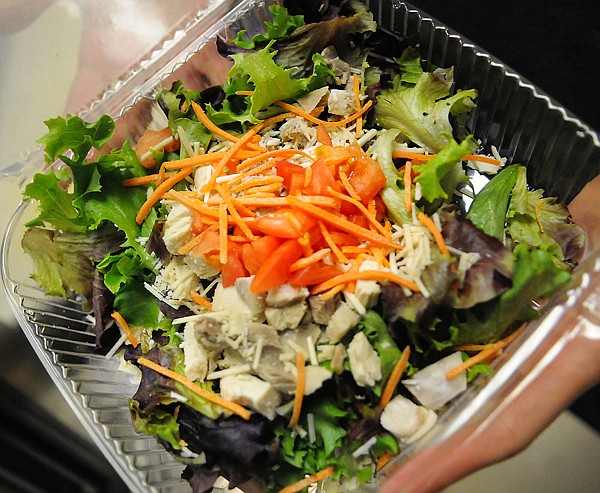 &lt;p&gt;Jenny Montague, the new food service director for District 5,
shows off one of the new colorful salads available for lunch at
Glacier High School on Thursday afternoon.&lt;/p&gt;