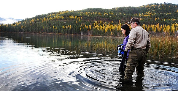 &lt;p&gt;From left, diver Sara Wilkinson and Gordon Jewett of the
Flathead County Weeds and Parks department discuss the section of
lake where Wilkinson will be diving and removing Eurasian Water
Milfoil.&lt;/p&gt;