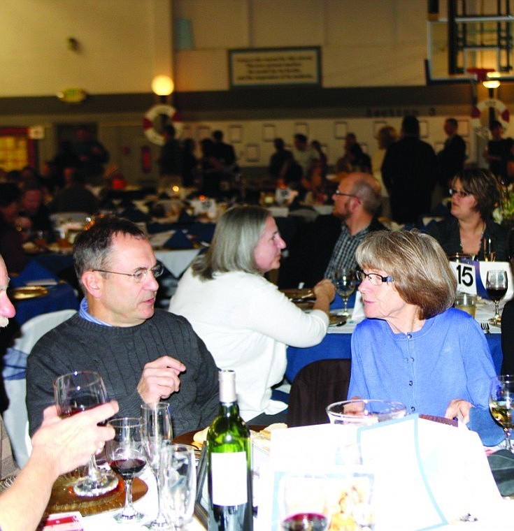 People visited and look at auction items displayed at the edge
of the gym during St. Rose of Lima Catholic School's auction
Saturday night.