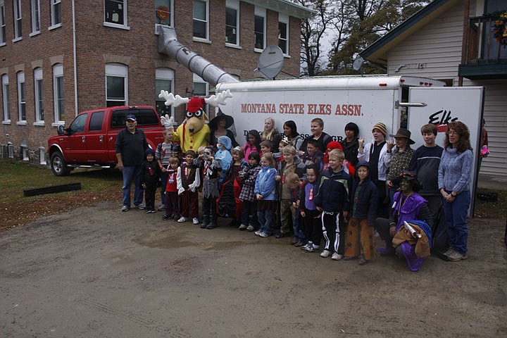 Fred Barrett and Elroy the Elk pose with students from the Paradise School in front of the Montana State Elks Association trailer.