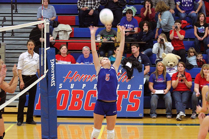 Rhandy Cox sets the ball in a match against Eureka during divisional volleyball playoffs.