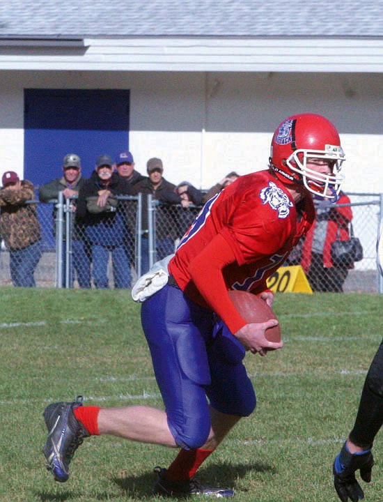 Quarterback Tanner Coon takes the ball downfield in a game agaist Fairfield on Staurday.