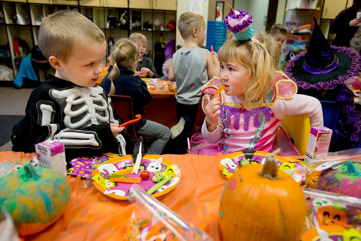 &lt;p&gt;Holy Family Catholic School pre-kindergarten students Kamden Holloway, left, chats with classmate Audrey Dinning as they snack on vegtable treats during their class' Halloween party on Thursday at Holy Family Catholic School.&lt;/p&gt;