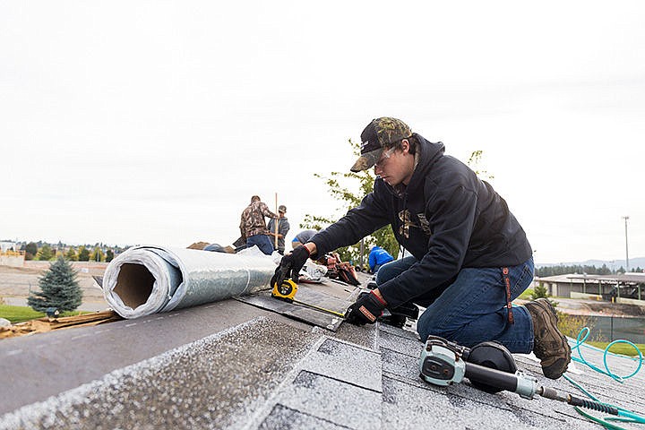 &lt;p&gt;Ian Rector, a junior at Kootenai Technical Education Campus, takes measurements on a piece of roofing material while reconditioning a roof for a Post Falls resident Thursday as part of Habitat for Humanity&#146;s Brush with Kindness Week.&lt;/p&gt;