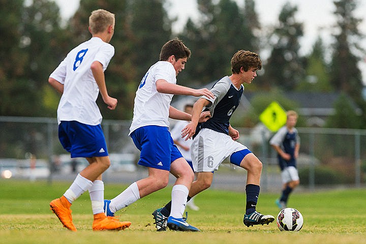 &lt;p&gt;Lake City High&#146;s Travis Swallow (6) beats Coeur d&#146;Alene defenders Colvin Dunteman, center, and Docker Bond for possession of the ball in the first half Thursday at Coeur d&#146;Alene High School.&lt;/p&gt;