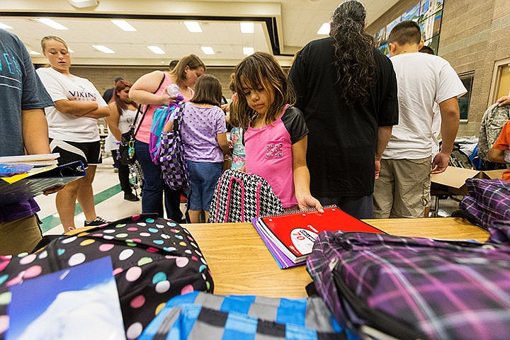 &lt;p&gt;Daisy Sailto, a second grade student at Bryan Elementary School, chooses school supplies to put into a backpack Thursday after a Coeur d&#146;Alene School District Indian Education Program back to school event at Woodland Middle School. More than 60 Native American students and family members attended the event.&lt;/p&gt;