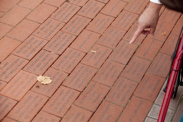 &lt;p&gt;Joan Mallonee looks at the memorial bricks at Depot Park in
Kalispell Friday morning.&lt;/p&gt;