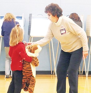 &lt;p&gt;Jillian Stewart, 4, receives here &quot;I Voted Today&quot; sticker from poll worker Darlene Hammons while waiting patiently for her grandparents to finish casting their ballots Tuesday morning.&lt;/p&gt;