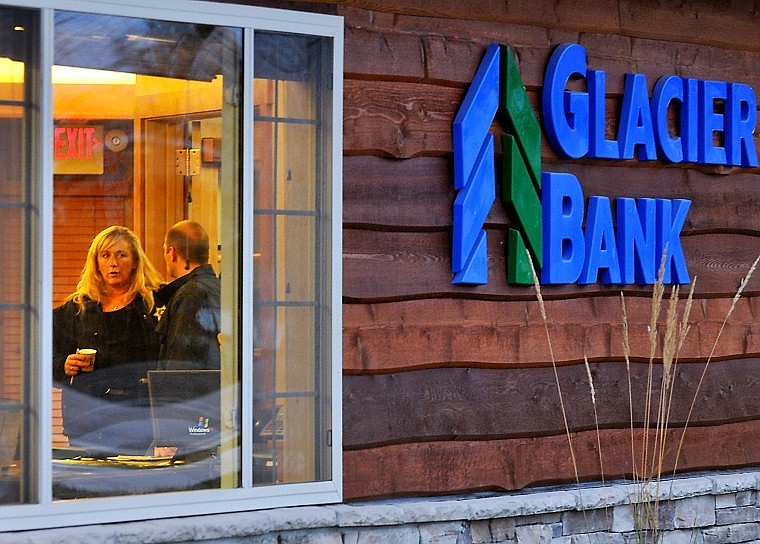 Flathead County Sheriff Detectives stand inside the Lakeside Glacier Bank branch late Wednesday afternoon. A robbery at the bank was reported at 4 p.m., with the suspect  seen leaving the bank on a white YZ Yamaha 185cc motorcycle headed west on Bierney Creek Road.