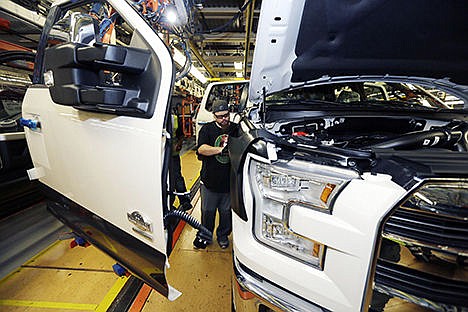 &lt;p&gt;In this Nov. 6 photo, Shawn Ebeler works on the door assembly on a new Ford F-150 truck is assembled at the Dearborn Truck Plant in Dearborn, Mich.&lt;/p&gt;