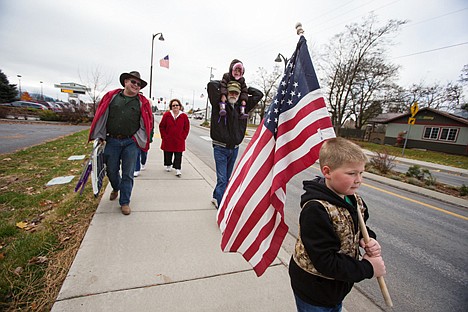 &lt;p&gt;Aiden Tomlinson, 7, of Post Falls, leads family members while displaying a large flag prior to Veterans Day celebrations in Hayden.&lt;/p&gt;