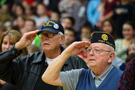 &lt;p&gt;Ronald Johnson, a 32-year veteran of the U.S. Navy, right, and Wesley Smith, a Navy veteran of 20 years, salute during the singing of the National Anthem Monday during a Veterans Day assembly at Post Falls Middle School.&lt;/p&gt;